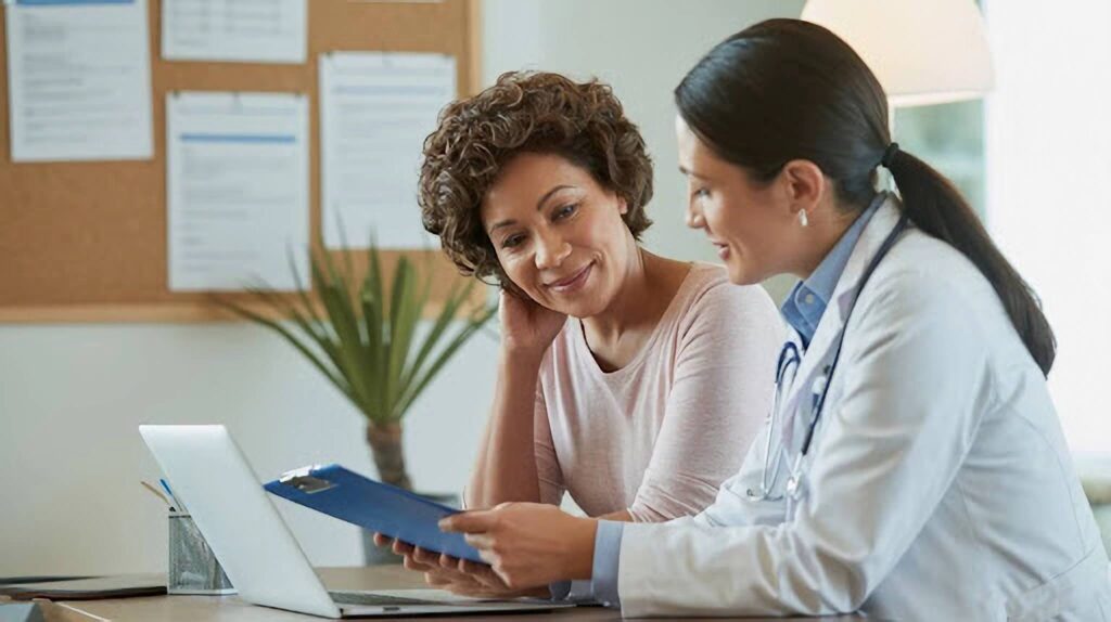 Doctor reviewing insurance paperwork for GLP-1 weight loss therapy